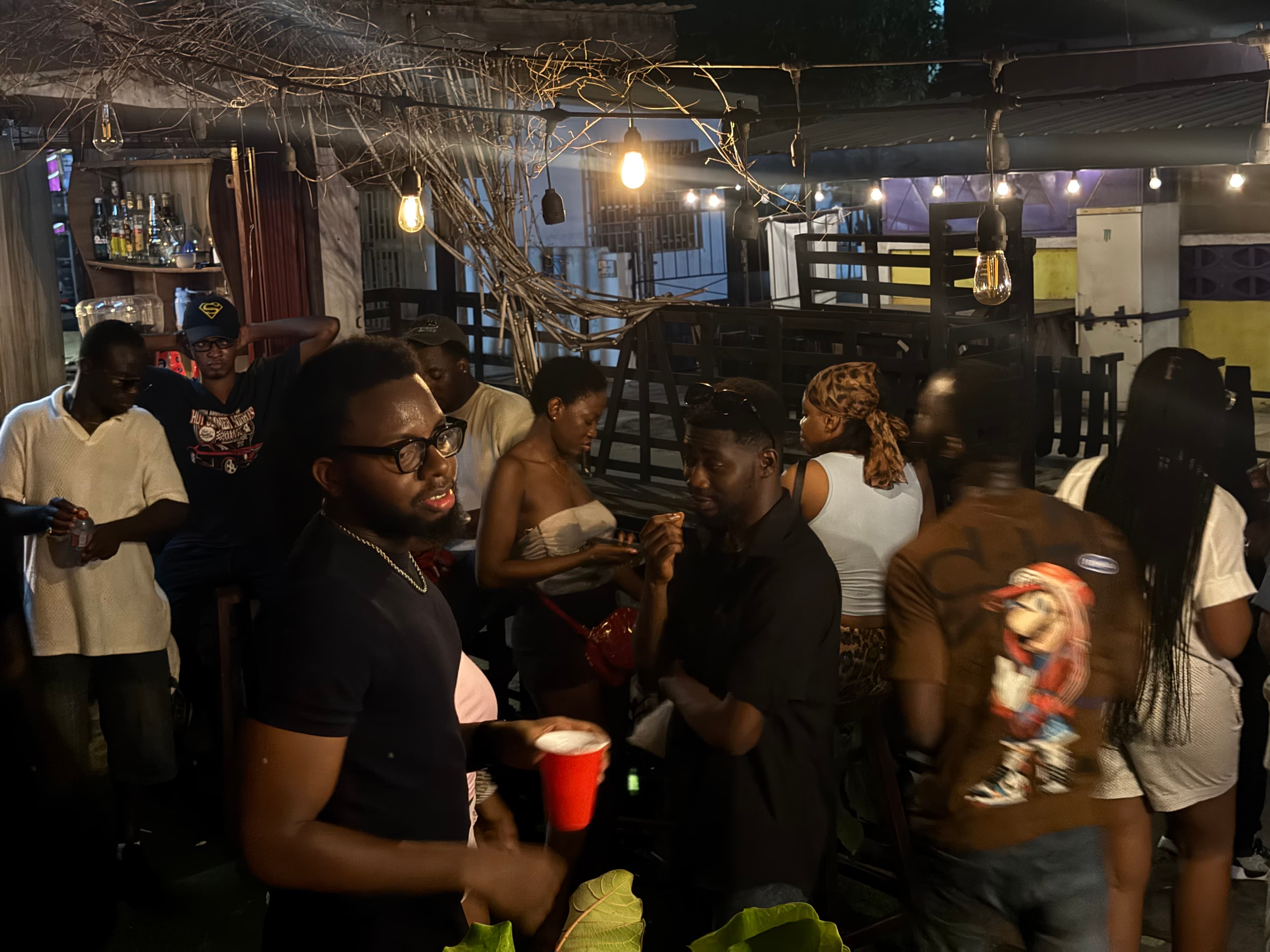 A courtyard at night with people in the room